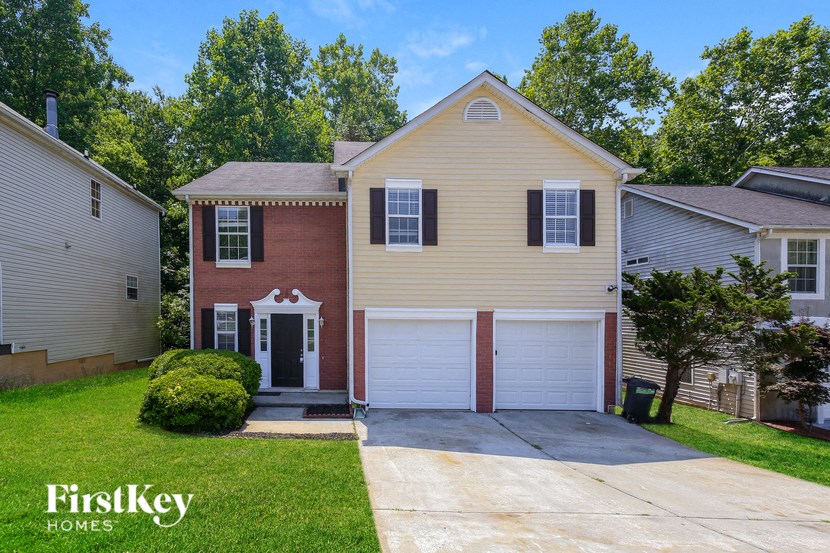 a yellow house with a white garage door