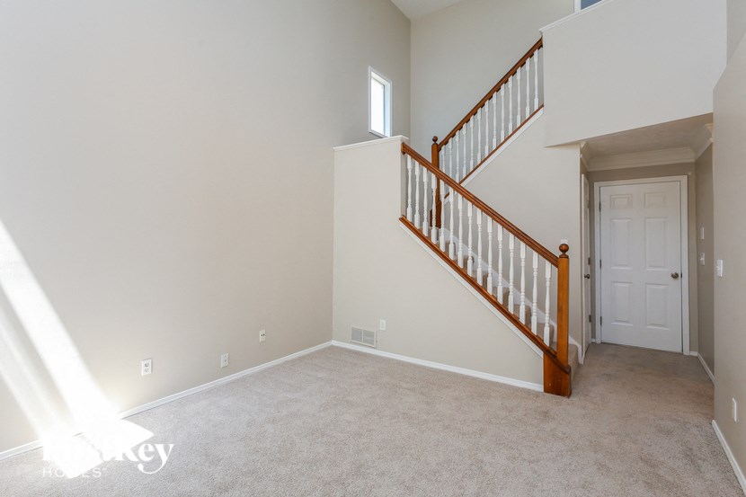 a white room with a staircase and a white door