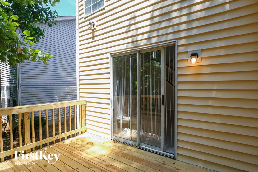 a patio with a sliding glass door on a house