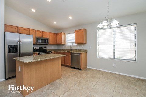 A kitchen with wooden cabinets and a granite countertop.
