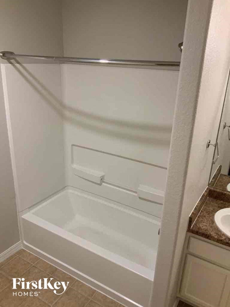 a small bathroom with a shower and a sink