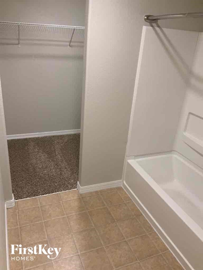 a small bathroom with a shower and a bath tub