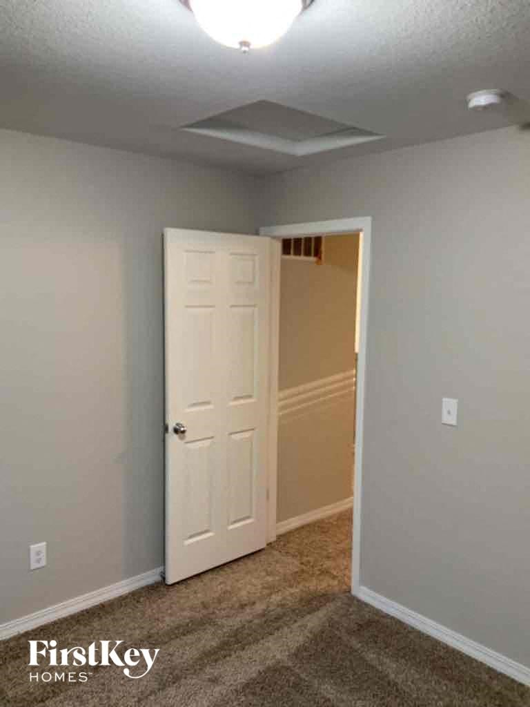 an empty room with a white door and a closet