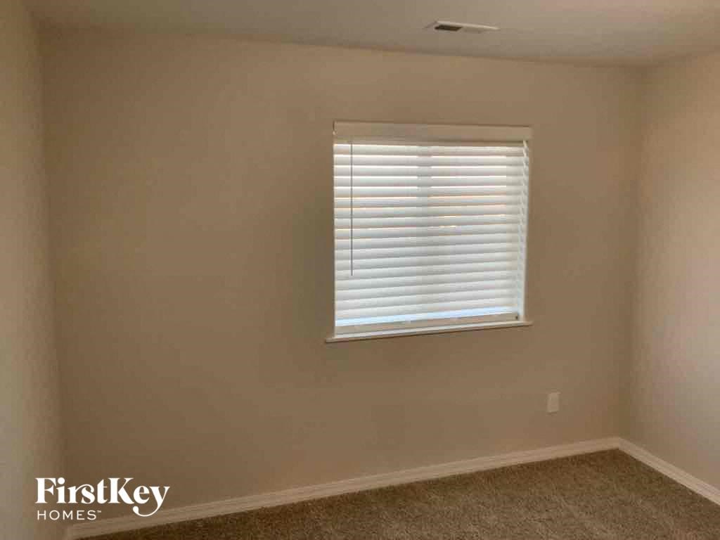 a room with a window and a carpeted floor
