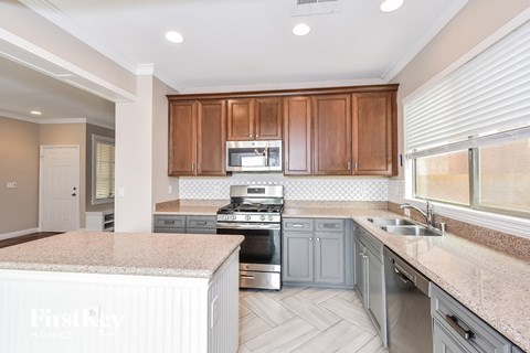 A kitchen with a stove top oven and microwave.