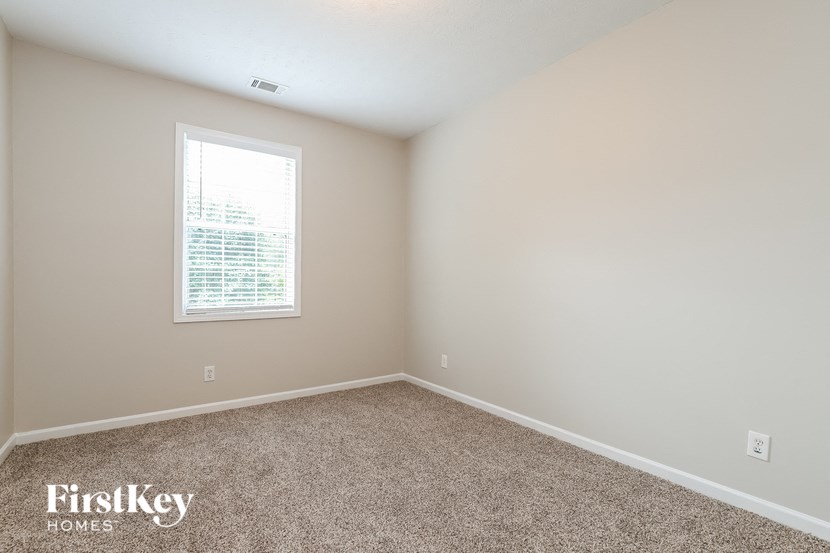 a room with carpet and a window
