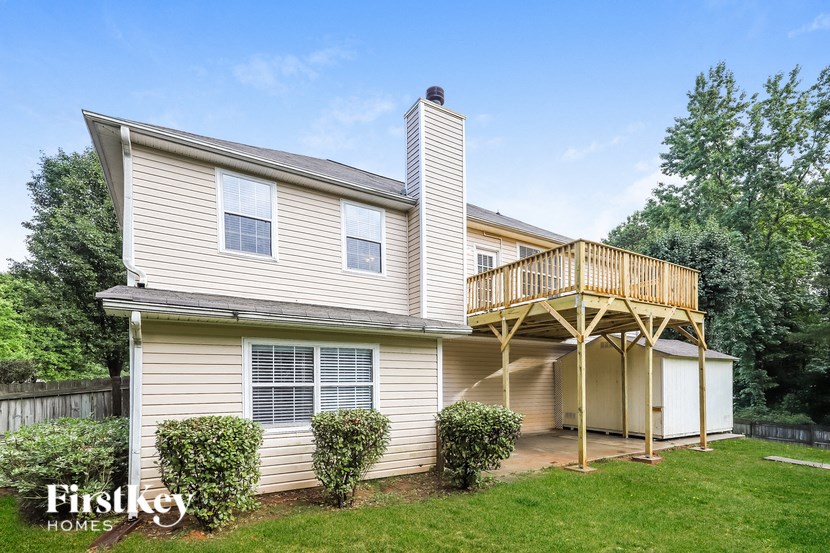a house with a wooden deck on the side of it