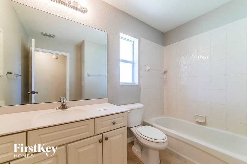 a bathroom with a sink toilet and a bath tub
