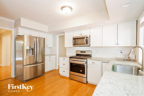a kitchen with stainless steel appliances and white cabinets