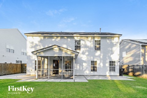 the exterior of a white house with a glass porch