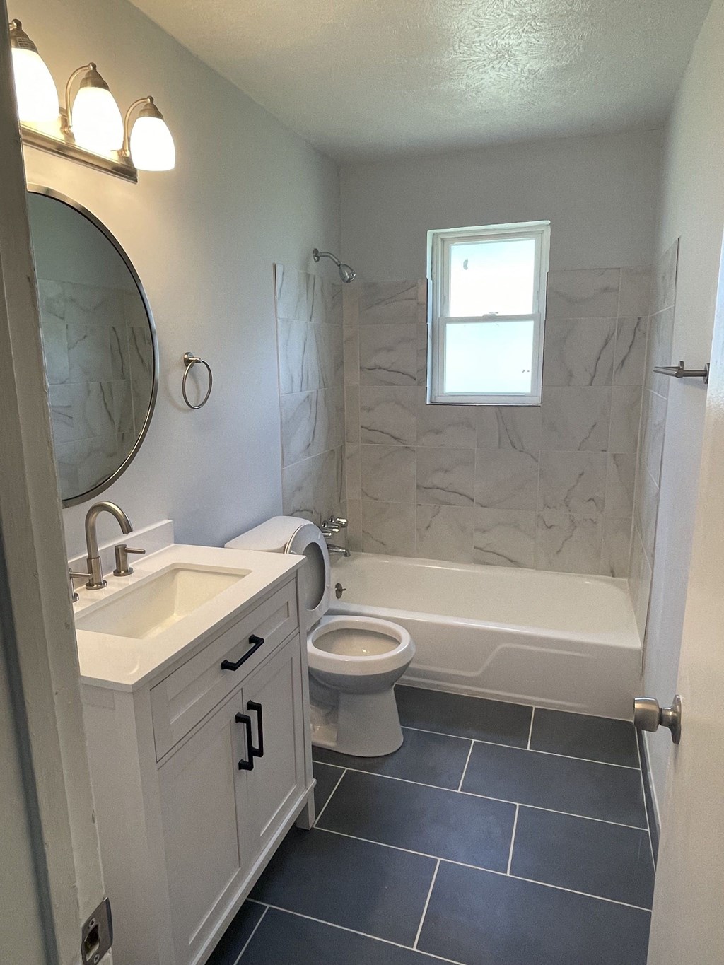 a bathroom with a sink toilet and a bath tub