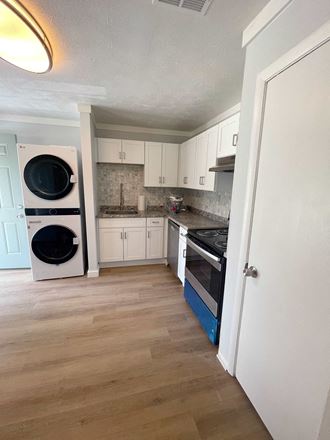 a small kitchen with a washer and dryer in it