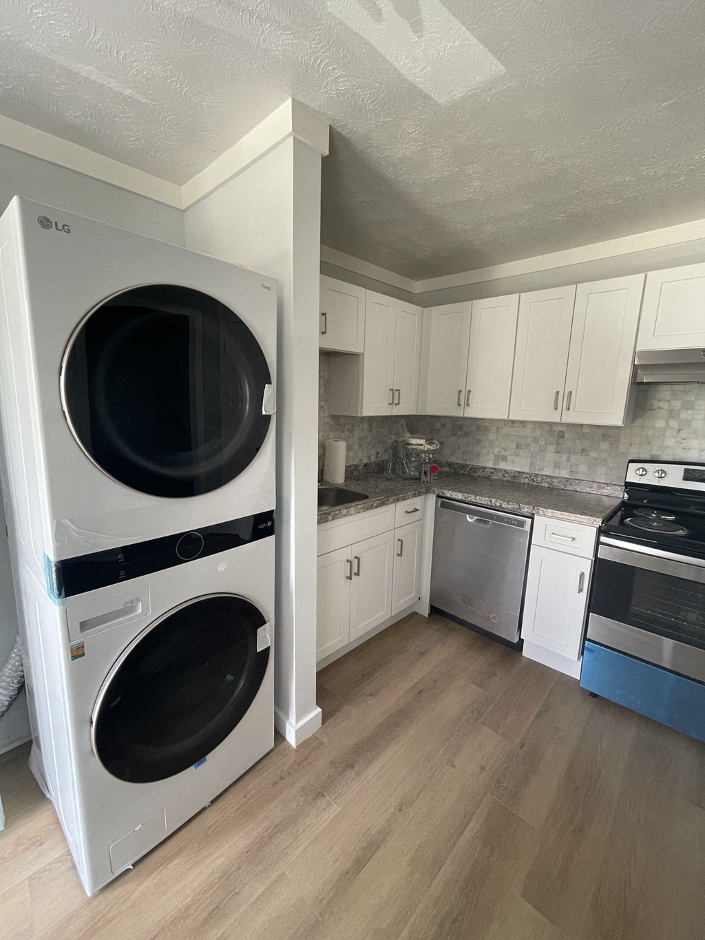 a kitchen with a washer and a dryer in it
