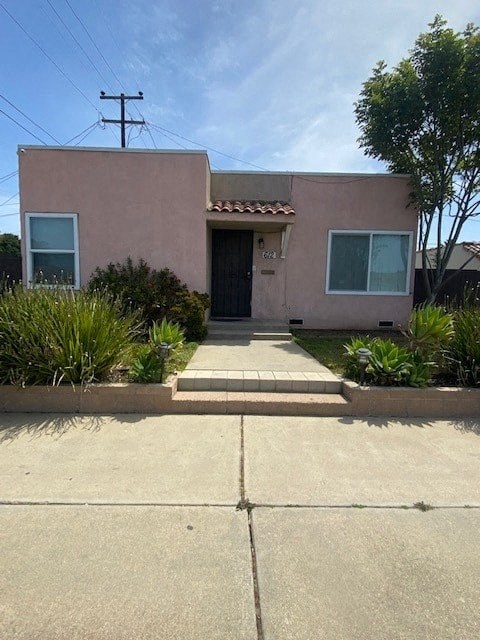 A house with a black door and a small porch.