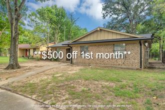 a house with a yard and a sign that says 500 off 1st month
