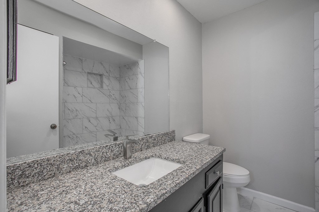 an empty bathroom with a sink and a mirror