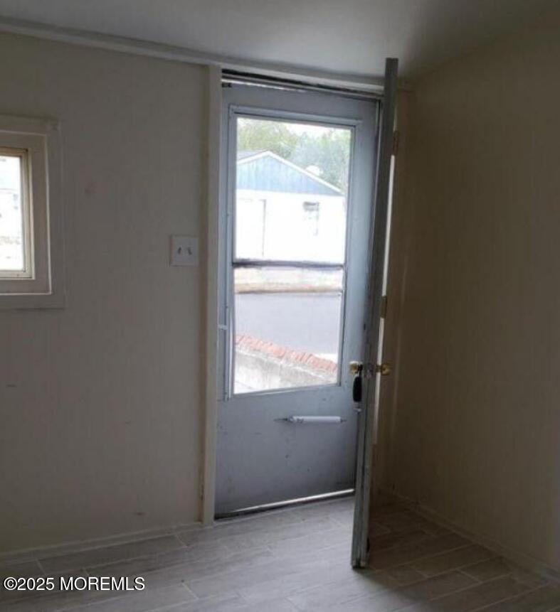 A room with a door leading to a balcony.