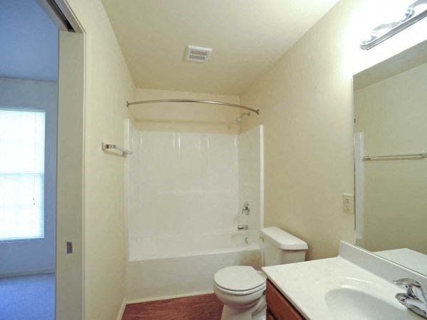 a bathroom with a toilet and a sink and a shower