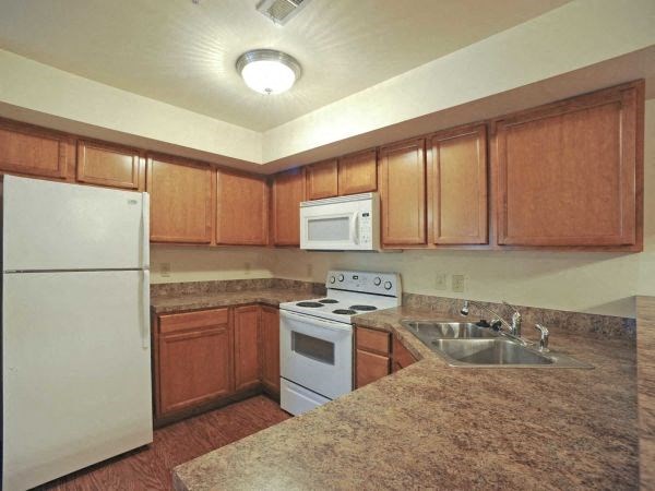a kitchen with a sink and a stove and a refrigerator