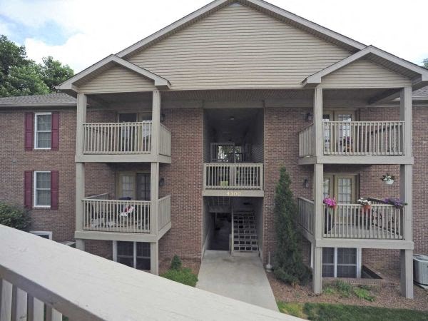 a brick apartment building with two balconies
