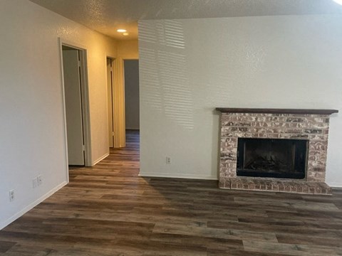 a living room with a fireplace and a wooden floor