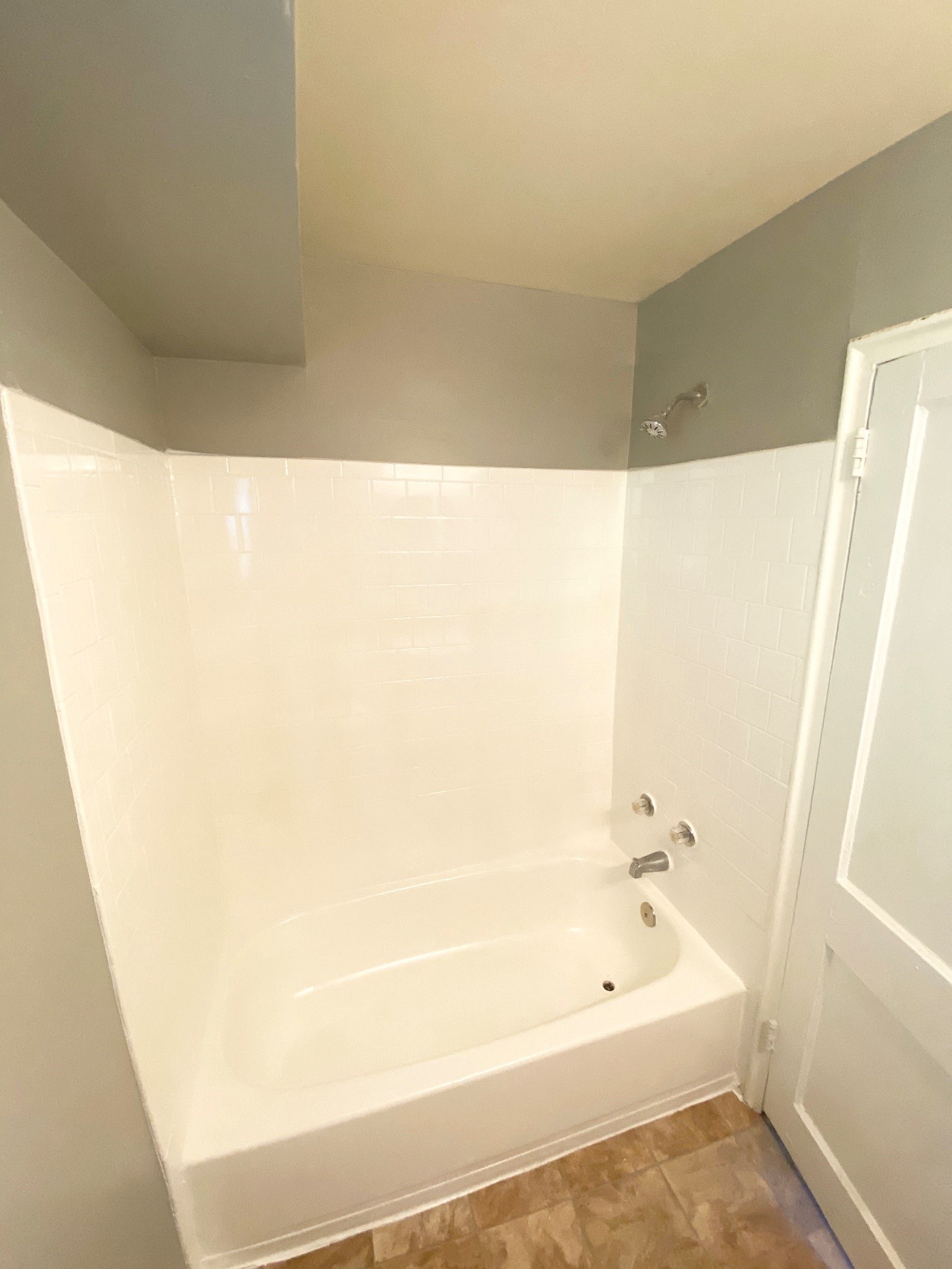 a small bathroom with a tub and a shower