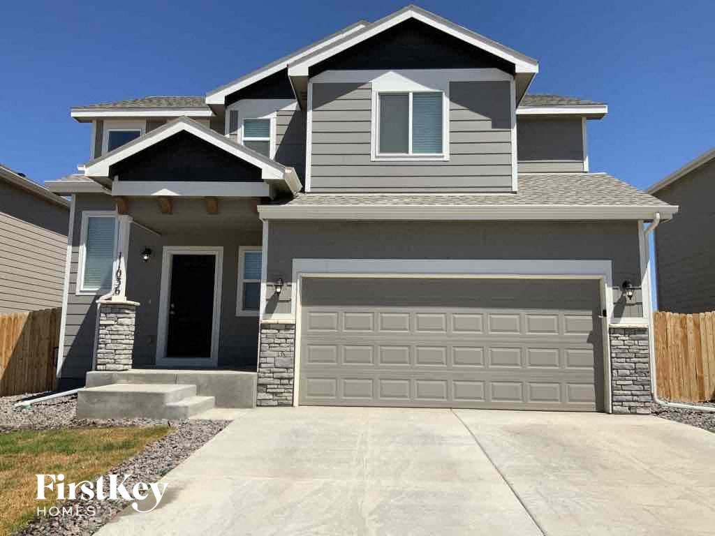 A modern two-story house with a garage is showcased.