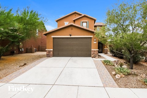 a clean driveway in front of a house with a garage door