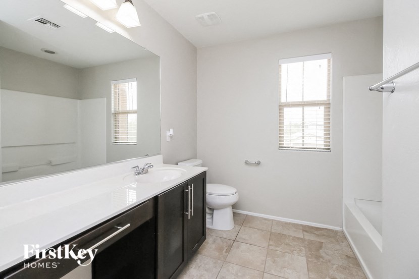 a bathroom with a sink and a toilet and a mirror
