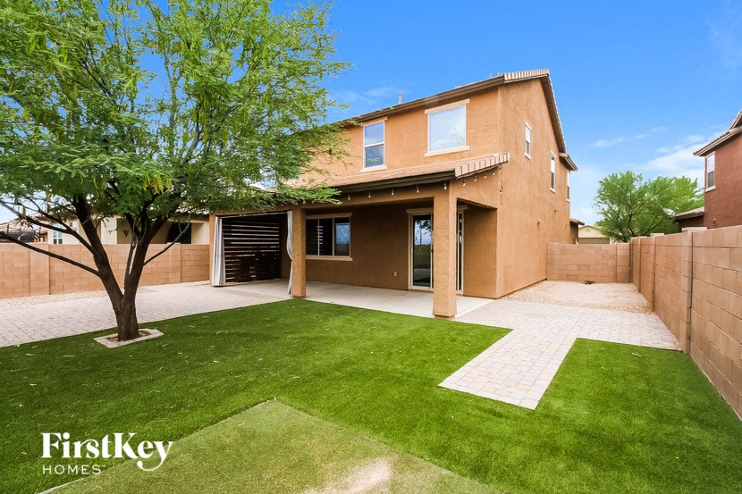 a backyard with a lawn and a house