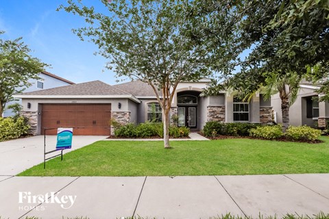 a house with a driveway and a mailbox in front of it