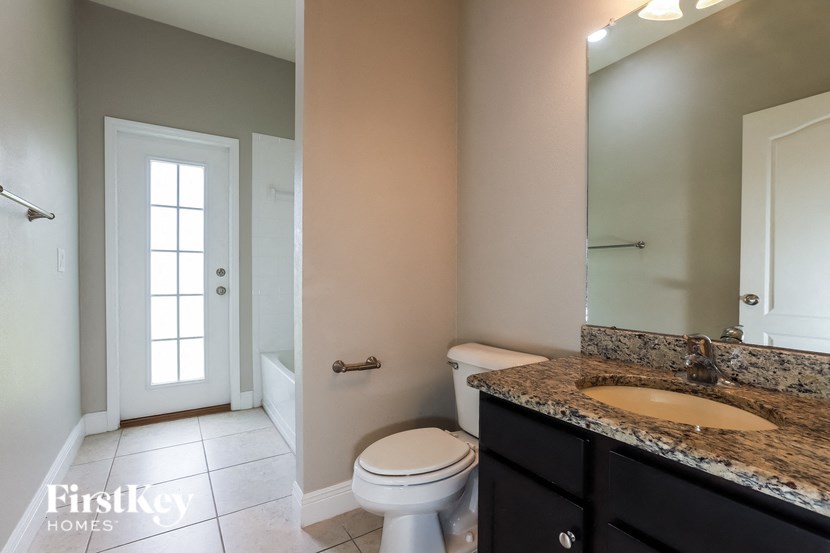a bathroom with a toilet and a sink and a mirror