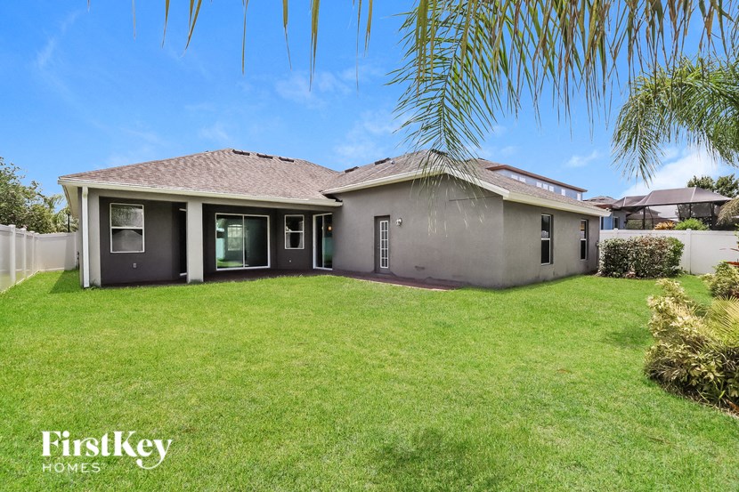a house with a lawn and palm tree