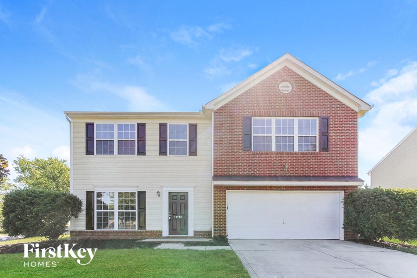 a brick and with a white garage door