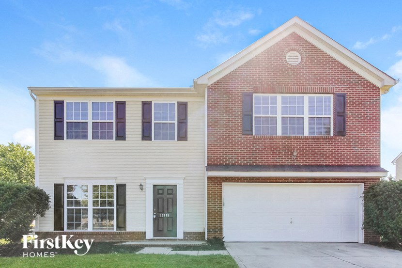 a brick and with a white garage door