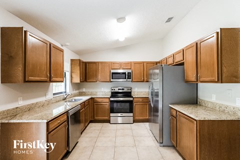 A kitchen with wooden cabinets and stainless steel appliances.