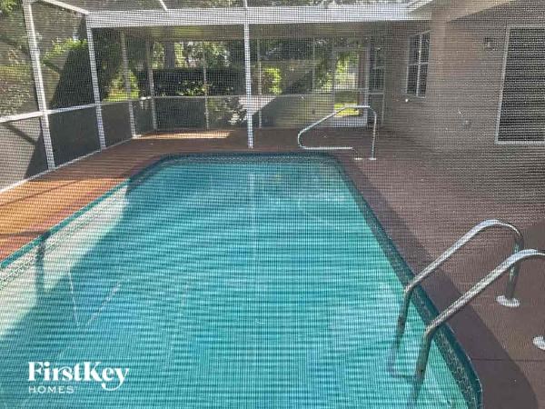 a large swimming pool with a fence around it