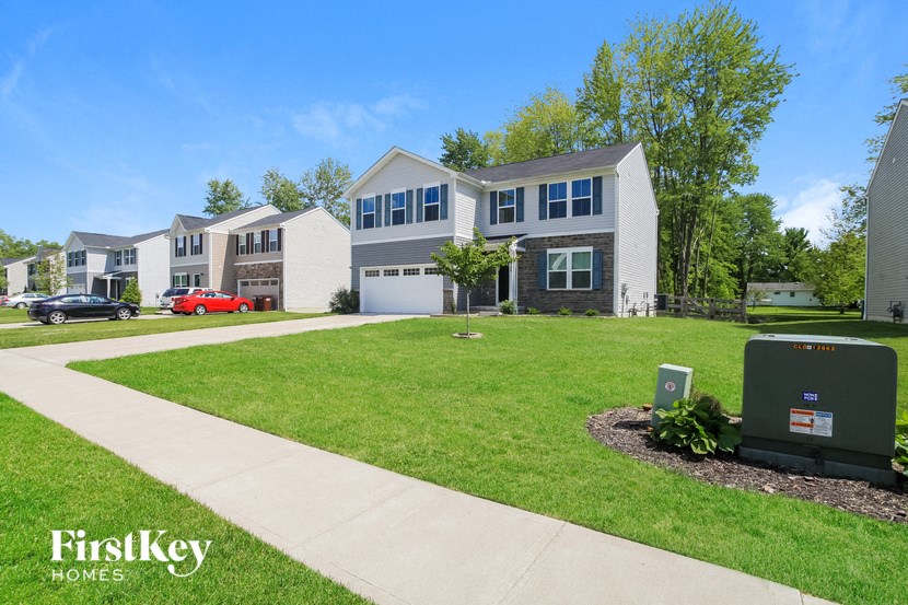 a lawn in front of a row of houses