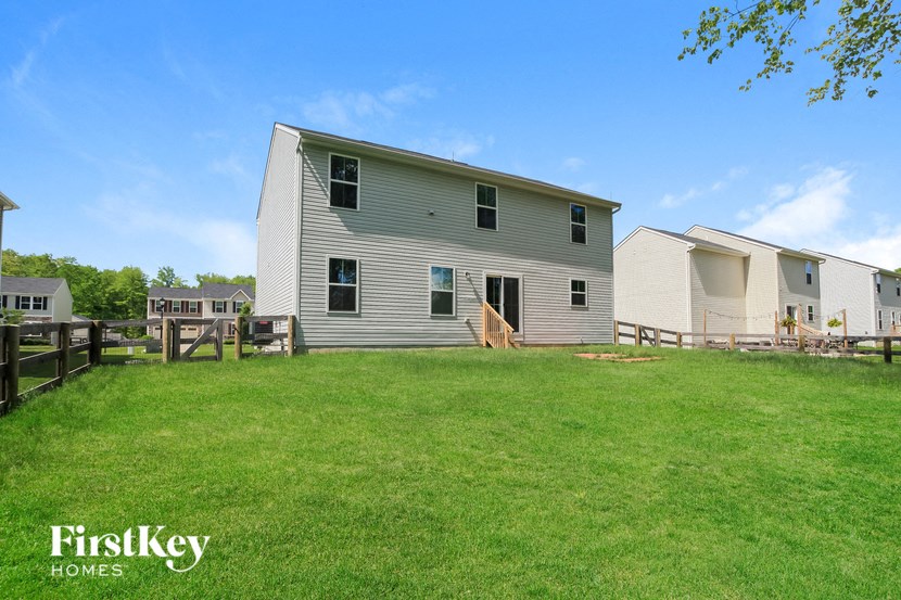 a white house with a yard in front of it