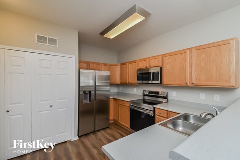 a kitchen with stainless steel appliances and wooden cabinets