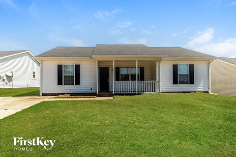 A house with a lawn in front of it.