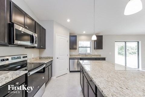a modern kitchen with granite counter tops and stainless steel appliances