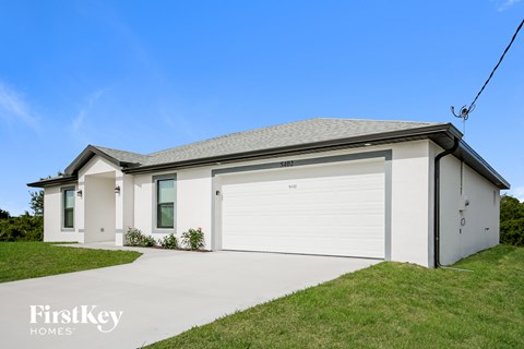 A two-story house with a garage on the side.