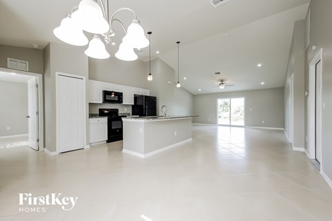 A spacious kitchen and living room with a modern design.