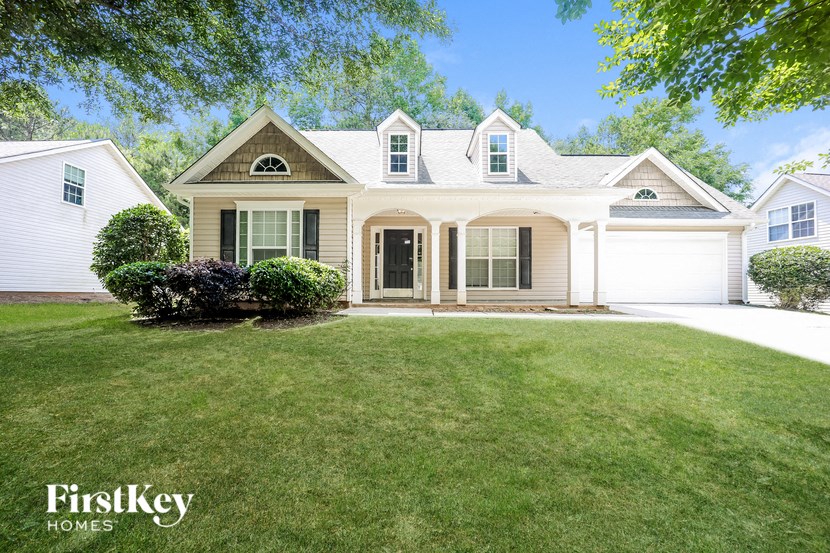 a white house with a lawn in front of it