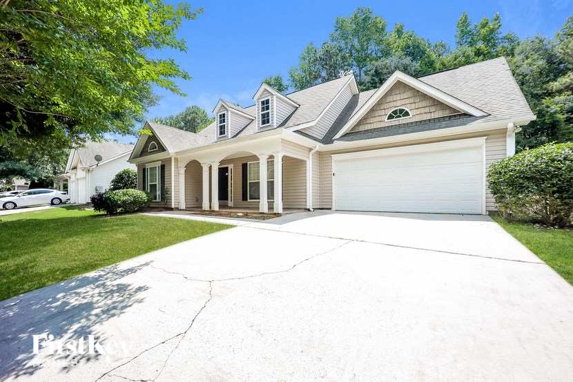 a white house with a driveway and a garage door