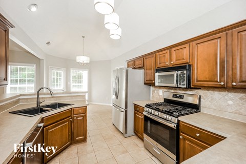 a kitchen with stainless steel appliances and wooden cabinets