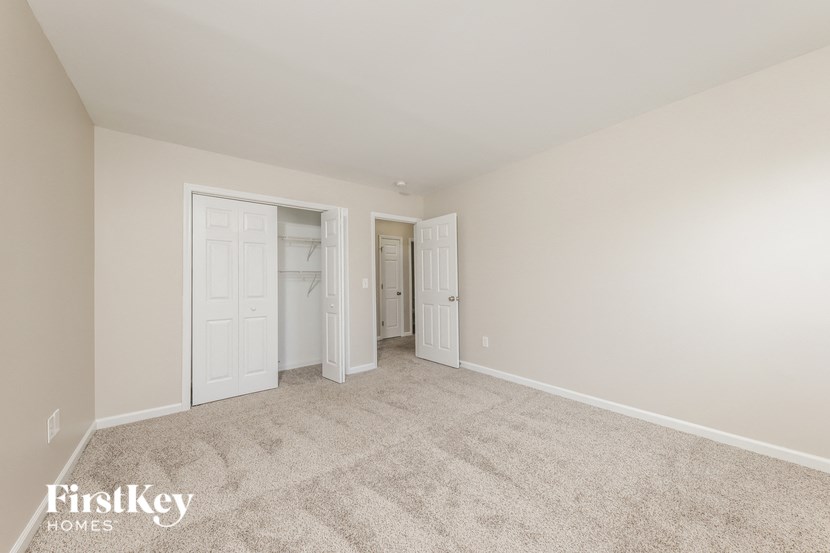 a bedroom with a carpeted floor and white doors