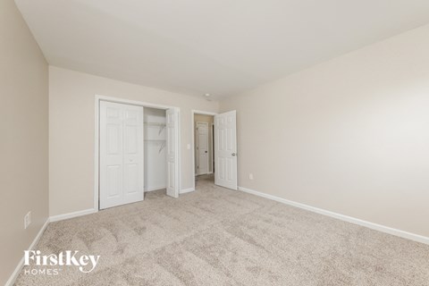 a bedroom with a carpeted floor and white doors