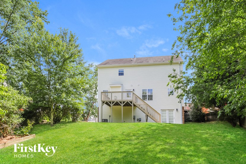 a large white house on top of a green lawn